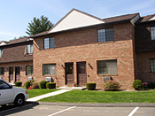 A brick building with cars parked in front of it.