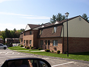 A car parked in front of a row of houses.