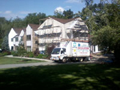 A moving truck parked in front of a house.