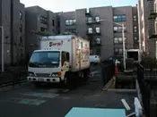 A white truck parked in front of some buildings.