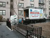 A moving truck parked on the side of a road.