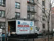 A truck is parked in front of a building.