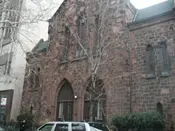 A church with a car parked in front of it.