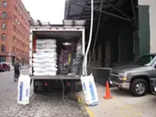 A truck with bags of cement on the back