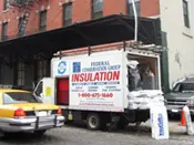 A truck with insulation on the back of it.