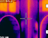 A close up of the side of a building with an ir camera.