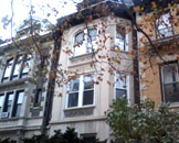 A building with many windows and trees in the background