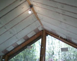 A ceiling with lights and windows in the background.