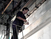 A man standing on top of a ladder.