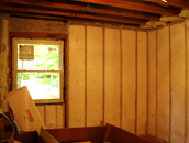 A room with wood paneling and a window.