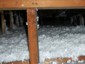 A pile of snow in the middle of an attic.