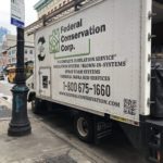 A white truck parked on the side of a street.