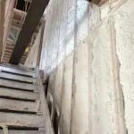 A view of the inside of a building with insulation on it.